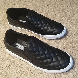 Steve Madden black slip ons.